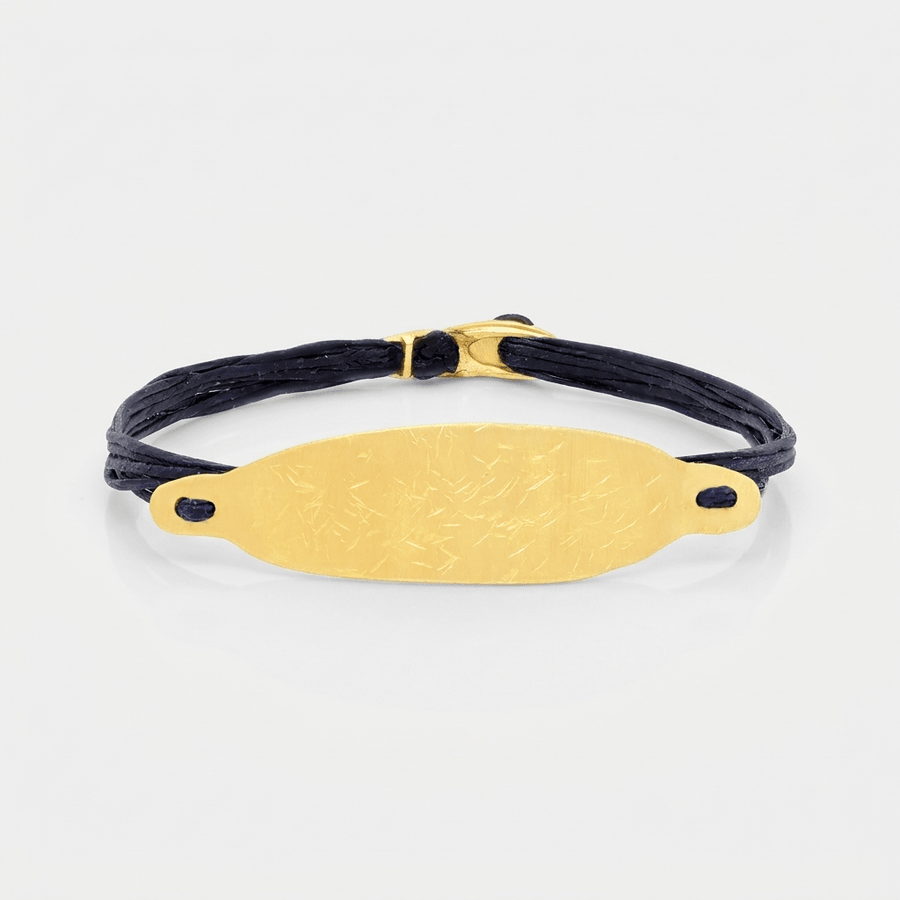 14K Gold Wide Bar Bracelet featuring a hand-hammered solid 14K gold plate and bench-made clasp.